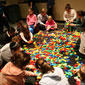 Volunteers join FC kids to build a giant Lego menorah